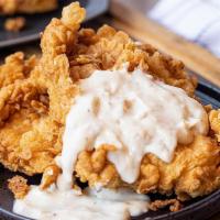 Chicken Fried Chicken · Two hand-breaded, all-natural chicken breasts fried & . topped with white pepper gravy.