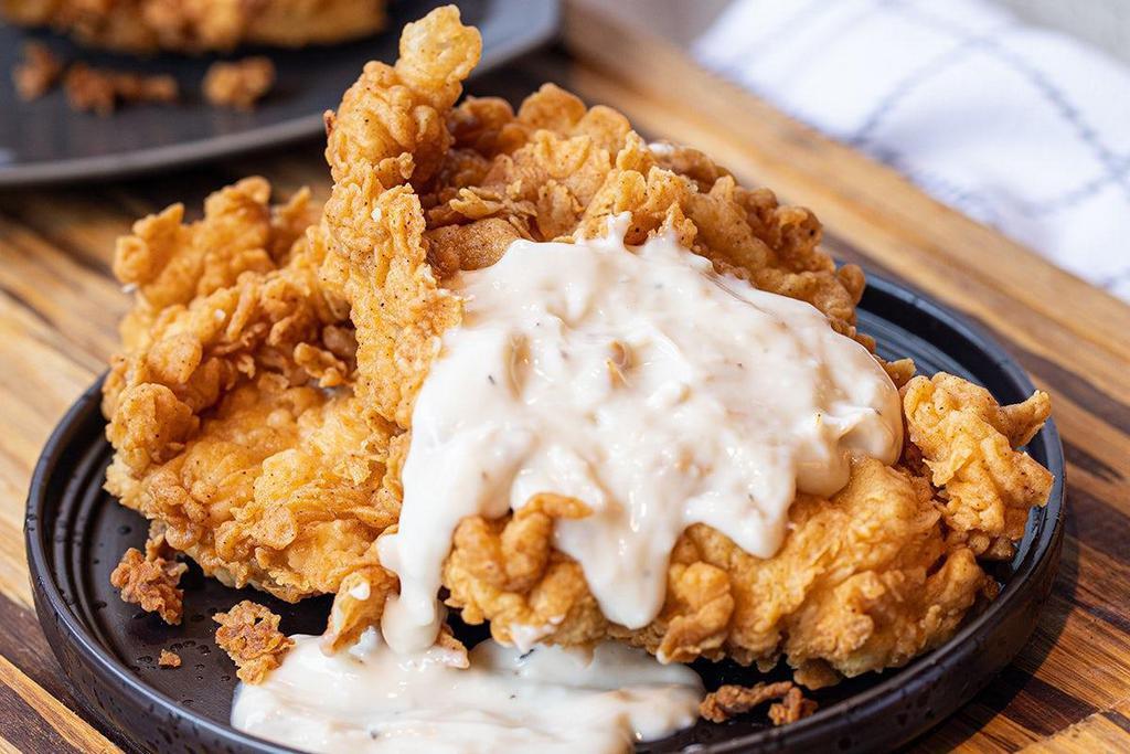 Chicken Fried Chicken · Two hand-breaded, all-natural chicken breasts fried & . topped with white pepper gravy.