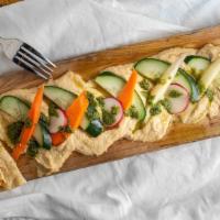 Hummus Board · Garlic hummus, carrots, cucumbers, radish, basil pesto, honey drizzle, pita bread.