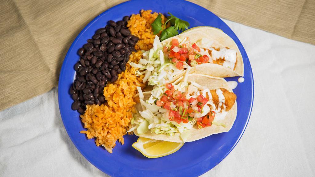 Creek Side Fish Tacos (2) · Grilled or fried cod tacos topped with garlic white sauce, chopped cabbage, pico de gallo, and served with rice and choice of refried or black beans. Choice of corn or flour tortillas.