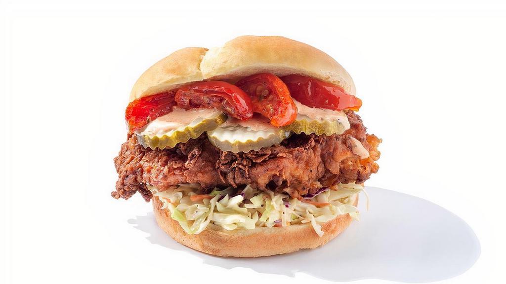 Roasted Tomato Cluck · Deep fried Nashville chicken, Roasted tomato, pickles, home made coleslaw, and a soft buttered bun