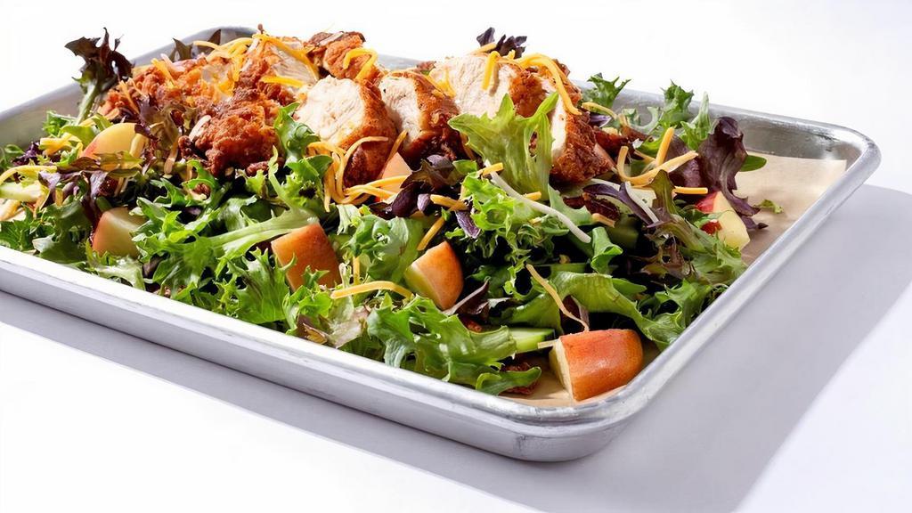 Apple Pecan Salad · Sliced 5oz Nashville Hot Chicken breast, Sliced crisp apples, cucumbers, Candied Pecans , Blue cheese crumbles, on a bed of greens. Served with a balsamic vinaigrette dressing on the side.