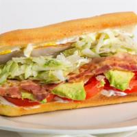 Smoked Turkey, Bacon And Avocado · Piled with smoked turkey, bacon and avocado. Topped with lettuce, tomato, onions, mayo, must...