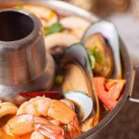 Tom Yum Seafood  · Hot and spicy soup with Seafood, mushroom, and tomatoes flavored with lemongrass, kaffir lim...