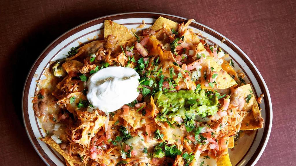 The Original Durango Nachos · Tortilla chips, melted jack cheese, tomatoes, onions, jalapeños, beans, guacamole and sour cream. Your choice of shredded chicken or ground beef.
