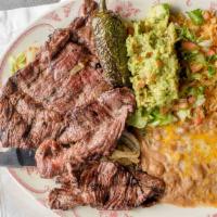 Carne Asada · A generous skirt of beef steak, char-broiled and garnished with onions. Served with rice, be...