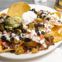 Felt Nachos · A heapin' mound of tortilla chips covered in melted cheese, topped with sour cream, ground b...