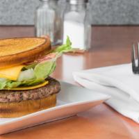B-9. Bacon Sourdough Burger · American, swiss, bacon, sautéed onion, lettuce, pickle with house ranch dressing.
