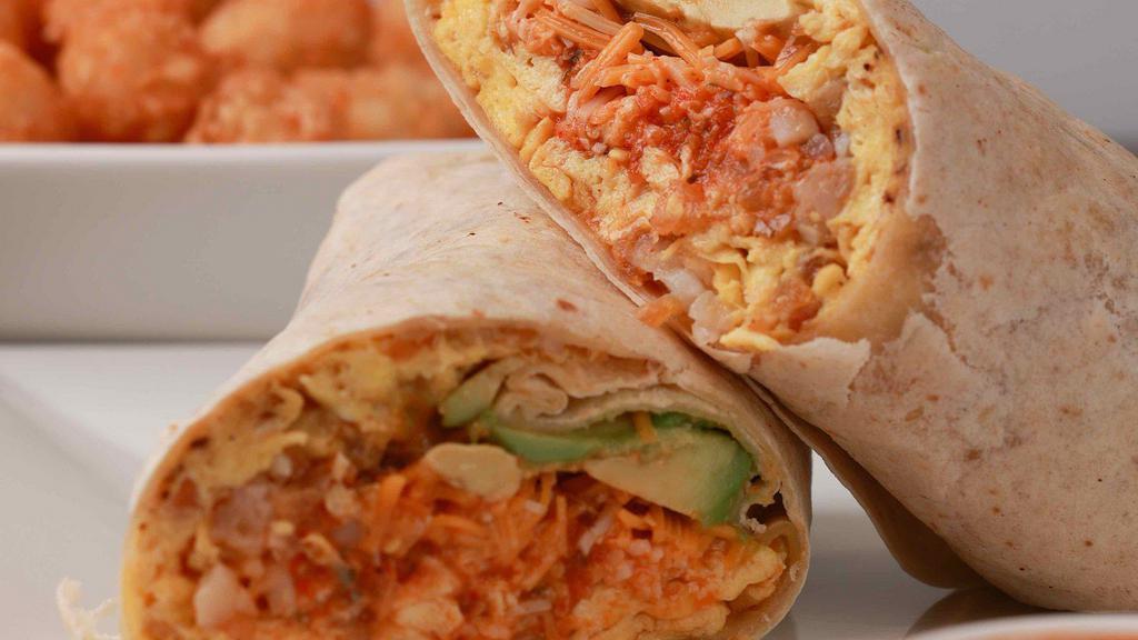 The Lucky Charm · Eggs, tater tots, ham, avocado, hot peppers, salsa roja and mixed cheese rolled in a flour tortilla wrap. Served with hot sauce.