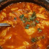 Spicy Tofu Soup · Spicy soft tofu stew with vegetables. Choice of beef / pork / seafood / vegetable.