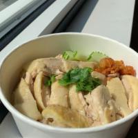 Kao Mun Gai · Ginger rice top with steam chicken serve with clear chicken bone broth and ginger soy dressi...
