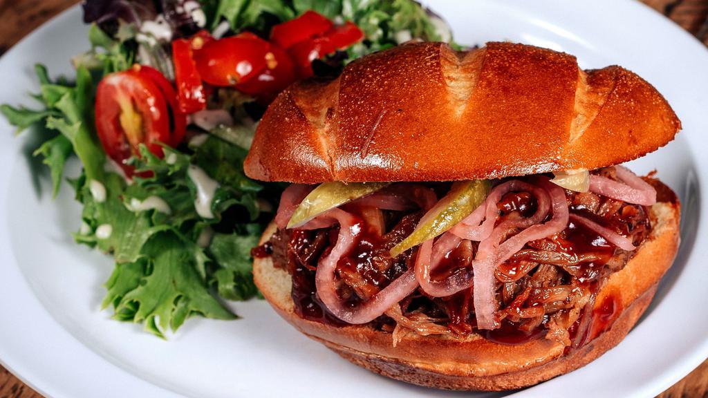 Bbq Pork · Slow roasted hand pulled pork, sweet savory BBQ sauce, House pickled red onions, dill pickles, Hawaiian bun.
