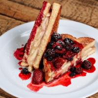 Stuffed French Toast · Sweet cream cheese filling, strawberries & warm berry compote, dusted with powdered sugar.