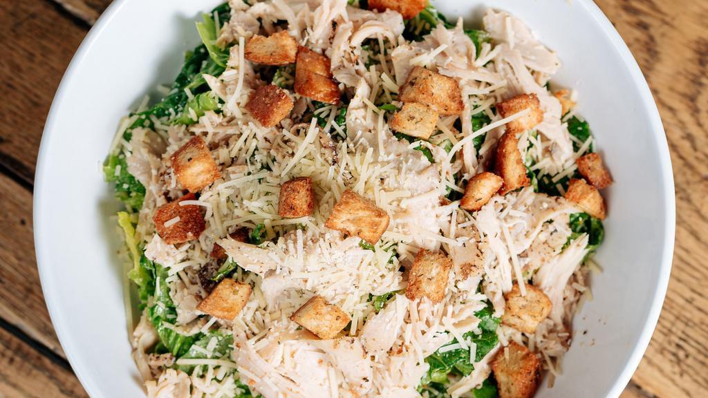 Caesar · Romaine lettuce, parmesean cheese, croutons, roasted chicken, and caesar dressing.