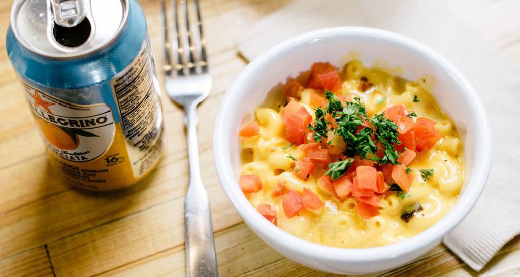 Loaded Mac · Creamy mac and cheese with a kick of poppin' cream cheese, bacon, chopped tomatoes and parsley.