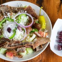 Greek Gyro Salad · Specially seasoned & flame broiled gyro meat atop our large Greek salad served with pita.
