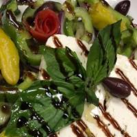 Greek Village Salad · Tomato, cucumber, onion, green pepper, feta, Greek olives** & pepperoncini served w/pita.