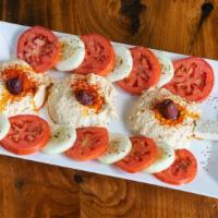 Hummus Plate · Hummus, tomato, cucumber, feta & Greek olives** served w/pita