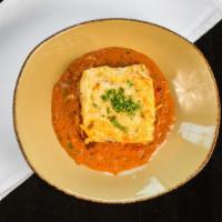 Pastitsio · Layered pasta, meat, creamy béchamel & tomato Mousaka sauce. Baked until golden brown. Toppe...