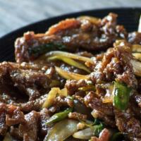 Mongolian Beef · Satisfying sliced beef stir-fried with scallions, onions and a savory ginger, garlic, chili,...