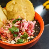 Black Bean · Topped with cabbage salad, verde sauce, plantain sauce, Queso Fresco and cilantro.