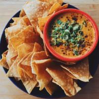 Smoky Queso Dip · House-made cheese sauce blended with green chiles, chipotle peppers, sauteed onions and garl...