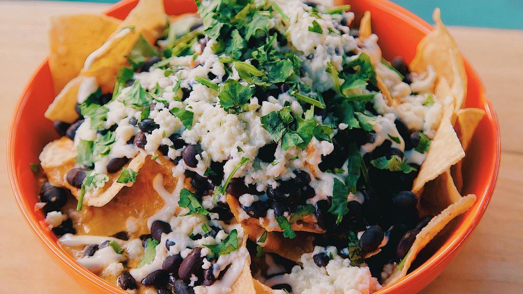 Masa Nosh · Our nachos. House-made tortilla chips topped with verde sauce, crema, black beans, smoky queso sauce, smoked gouda, queso fresco and cilantro. Add your choice of meat for an additional charge. Add guacamole for an additional charge.