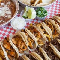 Assorted Taco Platter · 24 Tacos. 8 Steak, 8 Chicken, and 8 Al Pastor. Comes with sides of rice, beans, and chips. A...