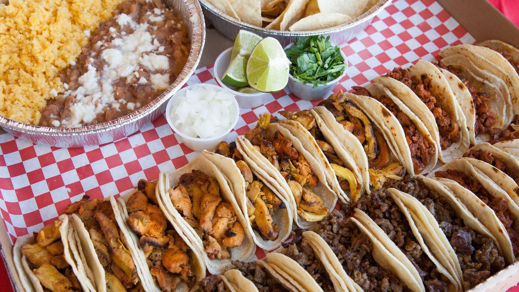 Assorted Taco Platter · 24 Tacos. 8 Steak, 8 Chicken, and 8 Al Pastor. Comes with sides of rice, beans, and chips. Also sides of cilantro, onion, and limes as toppings. 2 8oz cups of salsa included.