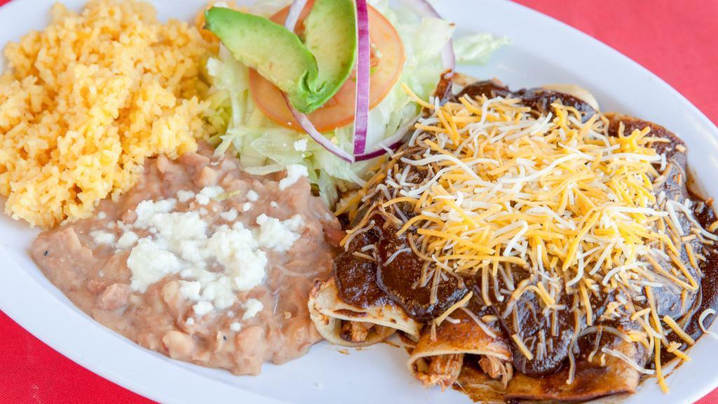 Red Mole Enchilada · Chicken Enchiladas smothered in Red Mole. With Side of rice, beans, and salad.