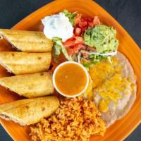 Chingolina · Flaky pastry filled with chicken. Served with rice and beans, garnished with guacamole, sour...