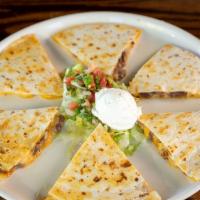 Quesadilla · Large flour tortilla, filled with melted cheese, topped with lettuce, Pico de Gallo and sour...