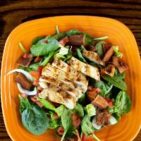 Spinach Chicken Salad · Fresh spinach and crisp romaine lettuce, tossed with tomatoes, onions, and bacon. Topped wit...