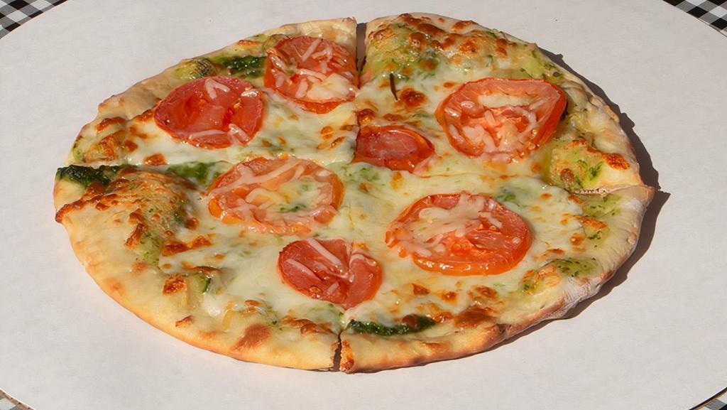 Juan Carlos Pesto · Spicy Juan Carlos Pesto Sauce, Mozzarella Cheese, Pine Nuts, Roma Tomatoes, Romano Cheese.  . Our Spicy Signature Take on a Pesto Pizza! Our JC Pesto Sauce is made with Jalapenos and Cilantro for an Extra Kick!  Try it with Daiya Cheese for a Delicious Vegan Option!