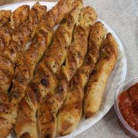 Garlic Bread Sticks · Our House-made Small Pizza Dough, Olive Oil & Garlic Sauce, and Herb & Cheese Sauce.  Served...