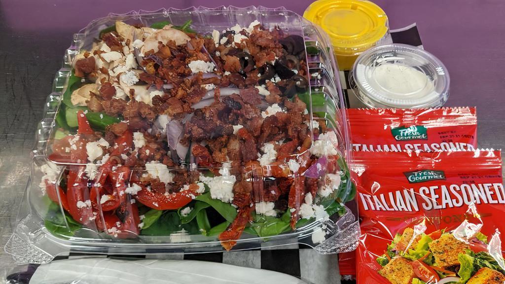 Spinach Salad · Baby Spinach, Red Onions, Black Olives,. Mushrooms, Sun-Dried Tomatoes, Roasted Red Peppers, Bacon, & Feta.  Served with Croutons and Your Choice of Dressing!