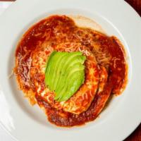 Huevos Rancheros · Corn tortillas layered with refried beans, two over easy eggs, melted jack cheese and our si...