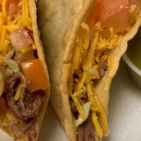Hard Shell Taco · Choice of chicken or shredded beef. Includes cheese, lettuce and tomato