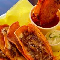 3 Queso-Birria Tacos · Marinated beef and cheese grilled tacos. Served with birria broth, onions and cilantro on th...