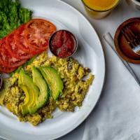Eggs Monterey Scramble · Mild California chili peppers, diced bacon and jack cheese, topped with avocado slices and s...