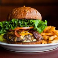 Dynamite Loaded Burger · Bacon, choice of cheese, caramelized onions, lettuce, tomato and burger spread. Served with ...