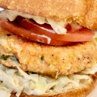 The Seattle Salmon Burger · Wild salmon cake ’house-made’, cabbage slaw, tomato slices, & tartar sauce