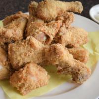 Fried Chicken · Whole fried chicken cut into 12 pieces with batter. Served with a side of pickled radishes.