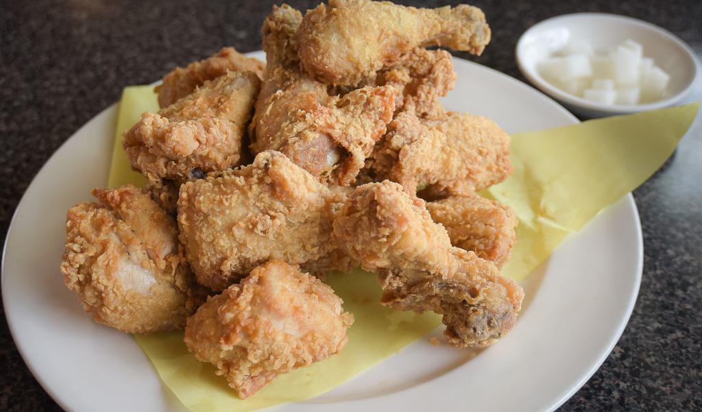 Fried Chicken · Whole fried chicken cut into twelve pieces with batter. Served with a side of pickled radishes.