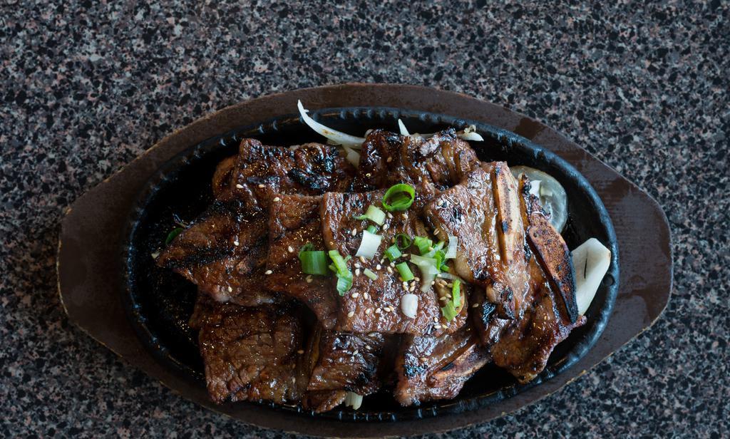 Kalbi · Korean bbq beef short ribs with kalbi sauce. Served with rice and side dishes.