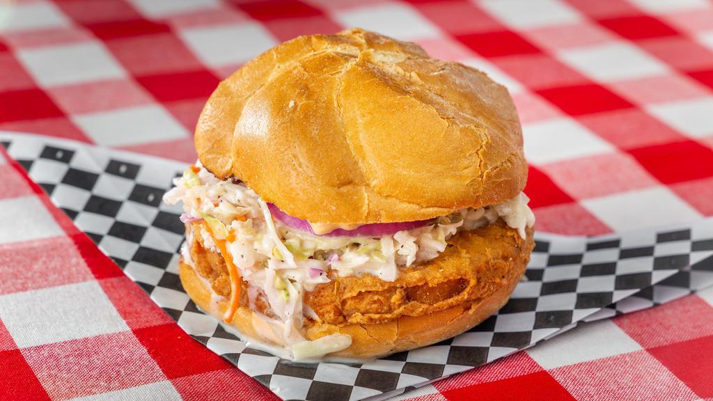 Chicken Sando · An amazing must try fried chicken Sandwich. Served on a brioche bun with spicy mayo, pickles, red onions and coleslaw.