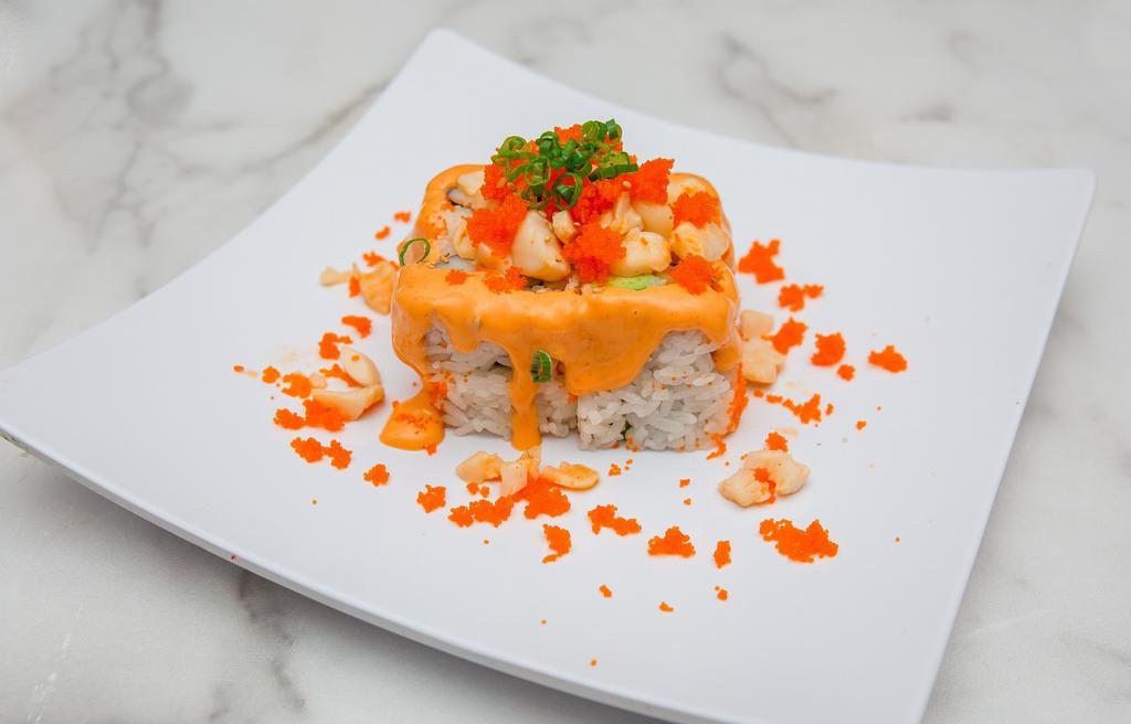 Volcano Roll · Imitation crab, avocado, cucumber and topped with baked scallops, masago, spicy mayo, and sesame seeds.
