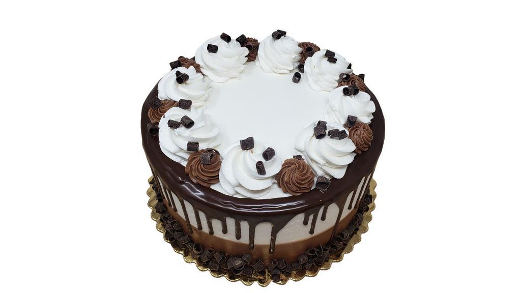 Marble Truffle Cake · Double layer cake is shown in image. Cake is decorated as shown and made with white and chocolate cake and iced with white and chocolate buttercream. Cake is then drizzled with chocolate truffle and finished with chocolate curls and buttercream rosettes. If you would like writing on your cake, please specify message in Special Instructions box.