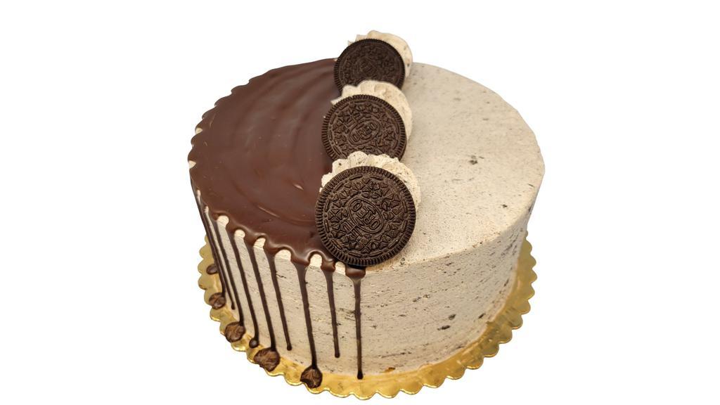 Cookies & Cream Cake · Double layer cake is shown in image. Cake is decorated as shown and made with chocolate cake and iced with a Whipped Cookies and Cream Icing. Drizzled with chocolate truffle and garnished with Oreo Cookies. If you would like writing on your cake, please specify message in Special Instructions box.