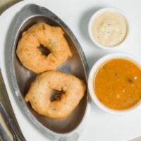 Medhu Vada (2 Pieces) · Fried lentil donuts. Served with sambar and chutney (Vegan).